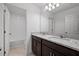 Bathroom with double sink vanity, granite countertop, and tile flooring at 7247 Rolling Leaf Rd, Groveland, FL 34736