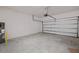 Clean, spacious two-car garage featuring an automatic door, water heater and concrete floor at 7247 Rolling Leaf Rd, Groveland, FL 34736