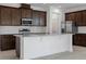 Modern kitchen features dark wood cabinets, granite countertops, and stainless steel appliances at 7247 Rolling Leaf Rd, Groveland, FL 34736