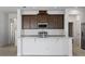 Bright kitchen boasts a large island, stainless steel appliances, and subway tile backsplash at 7247 Rolling Leaf Rd, Groveland, FL 34736