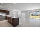 Open concept kitchen and living area with stainless steel appliances and sliding glass door at 7247 Rolling Leaf Rd, Groveland, FL 34736
