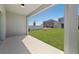 Covered patio overlooking a spacious yard with green grass, privacy fence, and neighboring homes at 7247 Rolling Leaf Rd, Groveland, FL 34736