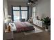 Modern bedroom with large windows overlooking the pool, featuring neutral tones and stylish furniture at 1833 Queen Palm Dr, Apopka, FL 32712