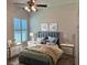 Cozy bedroom featuring contemporary decor, natural light, and comfortable bedding at 1833 Queen Palm Dr, Apopka, FL 32712