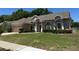 Single story home with a well manicured lawn and a two-car garage at 1833 Queen Palm Dr, Apopka, FL 32712