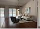 Bright living room with hardwood floors, a modern sofa, and access to the pool area at 1833 Queen Palm Dr, Apopka, FL 32712