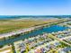 Aerial view of a neighborhood next to a lake and highway, showing community layout at 1911 Betsy Ross Ln, St Cloud, FL 34769