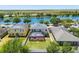 Aerial view featuring a backyard with a screened-in pool and lake at 1911 Betsy Ross Ln, St Cloud, FL 34769