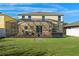 A covered patio, a backyard, and a white fence enhance this home at 1911 Betsy Ross Ln, St Cloud, FL 34769