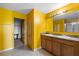 Bright bathroom with double sinks, wood cabinetry and a separate shower and toilet area at 1911 Betsy Ross Ln, St Cloud, FL 34769