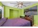 Cozy bedroom features a ceiling fan and large television for comfortable living at 1911 Betsy Ross Ln, St Cloud, FL 34769