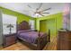 Comfortable bedroom with wood floors, ceiling fan, closet, and television for relaxing and watching TV at 1911 Betsy Ross Ln, St Cloud, FL 34769