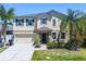 Charming two-story home featuring manicured landscaping and a welcoming front entrance at 1911 Betsy Ross Ln, St Cloud, FL 34769
