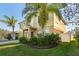 Well-maintained home showcasing lush greenery and a neatly kept lawn at 1911 Betsy Ross Ln, St Cloud, FL 34769