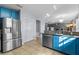 Spacious kitchen with blue cabinets, granite countertops, and stainless steel refrigerator at 1911 Betsy Ross Ln, St Cloud, FL 34769