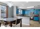 Bright kitchen featuring blue cabinetry, stainless steel appliances, a mosaic backsplash, and a breakfast bar at 1911 Betsy Ross Ln, St Cloud, FL 34769