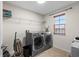 This laundry room features modern washer, dryer, and ample shelving at 1911 Betsy Ross Ln, St Cloud, FL 34769