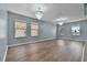 Large living room with hard surface floors and multiple windows at 1911 Betsy Ross Ln, St Cloud, FL 34769