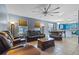 Spacious living room features a large ceiling fan, recessed lighting, and seamless flow into the dining area at 1911 Betsy Ross Ln, St Cloud, FL 34769