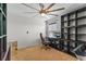 Home office with ceiling fan, and dark shelving unit, offering ample storage space at 1911 Betsy Ross Ln, St Cloud, FL 34769
