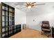 Office includes a ceiling fan, shelving unit, rolling chair, and ample room for productivity at 1911 Betsy Ross Ln, St Cloud, FL 34769