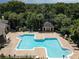 Aerial view of a large pool with a cabana surrounded by trees at 2624 Robert Trent Jones Dr # 623, Orlando, FL 32835