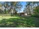 Large grass backyard with mature trees and foliage at 33629 Wesley Rd, Eustis, FL 32736