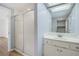 Neutral bathroom featuring a glass-enclosed shower and a vanity sink with mirror at 33629 Wesley Rd, Eustis, FL 32736