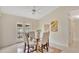 Dining room with glass table, vaulted ceiling, and bright natural light at 1957 Teaberry Ct, Orlando, FL 32824
