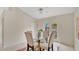 Dining room with glass table, vaulted ceiling, and bright natural light at 1957 Teaberry Ct, Orlando, FL 32824