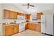 Traditional kitchen with wooden cabinets, tiled floor, and standard appliances at 1957 Teaberry Ct, Orlando, FL 32824
