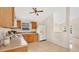 Functional kitchen features wood cabinets, white appliances, and a window providing natural light at 1957 Teaberry Ct, Orlando, FL 32824