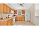 Traditional kitchen with wooden cabinets, tiled floor, and standard appliances at 1957 Teaberry Ct, Orlando, FL 32824