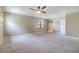 Spacious carpeted bedroom with a ceiling fan and natural light coming through the window at 2523 Madron Ct, Orlando, FL 32806