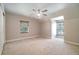 Bedroom with carpet and a ceiling fan with large windows allowing for great sunlight at 2523 Madron Ct, Orlando, FL 32806