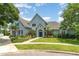 Charming home with a beautifully landscaped front yard, lush gardens, and a welcoming blue facade at 2523 Madron Ct, Orlando, FL 32806