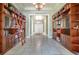 Hallway featuring built-in bookshelves with ladder and tile floors, offering ample storage at 2523 Madron Ct, Orlando, FL 32806