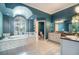 Luxurious primary bath featuring a soaking tub, blue walls, and vanity at 2523 Madron Ct, Orlando, FL 32806
