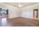 Spacious main bedroom with a ceiling fan, carpet, and a view to a luxurious bathroom at 2523 Madron Ct, Orlando, FL 32806