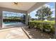 Covered patio looking out to the screened pool and scenic lake, with comfortable outdoor space at 2523 Madron Ct, Orlando, FL 32806