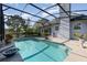 Screened-in pool is surrounded by lush landscaping offering a private and serene experience at 2523 Madron Ct, Orlando, FL 32806