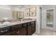 Bathroom featuring double sinks, granite countertops, and a walk-in shower with access to the pool at 3955 Lana Ave, Davenport, FL 33897