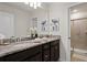 Elegant bathroom featuring dual sinks, granite countertops, and a glass-enclosed shower at 3955 Lana Ave, Davenport, FL 33897