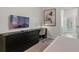 Comfortable bedroom featuring a TV, desk, and dresser with access to outdoor living at 3955 Lana Ave, Davenport, FL 33897