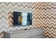 room with a decorative accent wall, modern dresser, and fun, playful design at 3955 Lana Ave, Davenport, FL 33897
