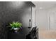 Modern office space showcasing a chic black textured wall and sleek black desk at 3955 Lana Ave, Davenport, FL 33897