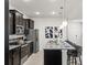Contemporary kitchen features stainless steel appliances, an island with seating, and sleek finishes at 3955 Lana Ave, Davenport, FL 33897