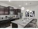 Modern kitchen boasts granite countertops, stainless steel appliances, and pendant lighting at 3955 Lana Ave, Davenport, FL 33897