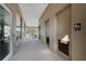 Hallway with mens restroom, windows looking onto the gym, and open access to the pool and outdoor seating area at 314 Rover Rd, Ormond Beach, FL 32174