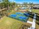 Aerial view of the green and blue pickleball courts adjacent to the play ground area at 314 Rover Rd, Ormond Beach, FL 32174